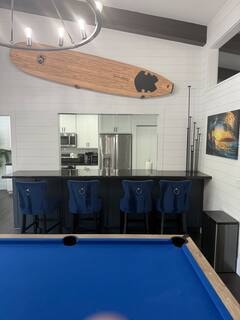 Bar area with blue velvet barstools and surfboard display