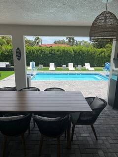 Covered outdoor dining with pool view
