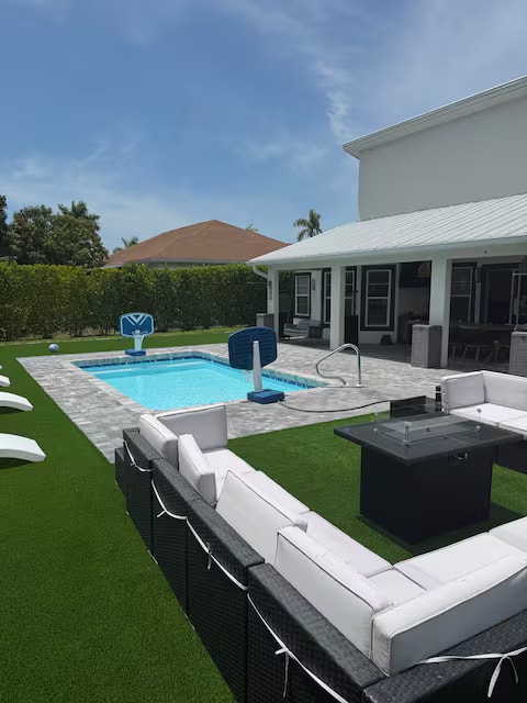 Private pool with basketball hoop and lounge area