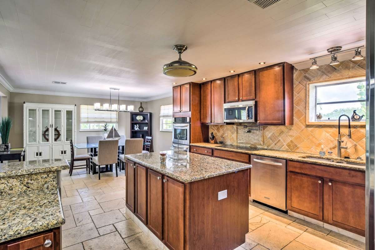 Kitchen with granite island and warm wood cabinets