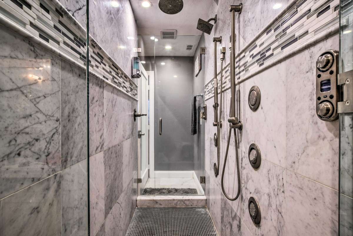 Marble walk-through shower with body jets
