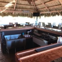 Tiki bar with thatched roof and full bar top