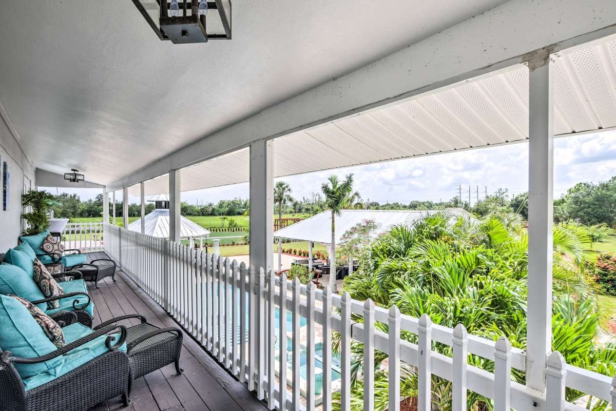 Upstairs balcony with teal seating overlooking the grounds